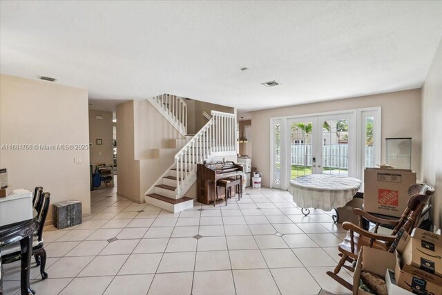 living room with french doors and light tile patterned floors