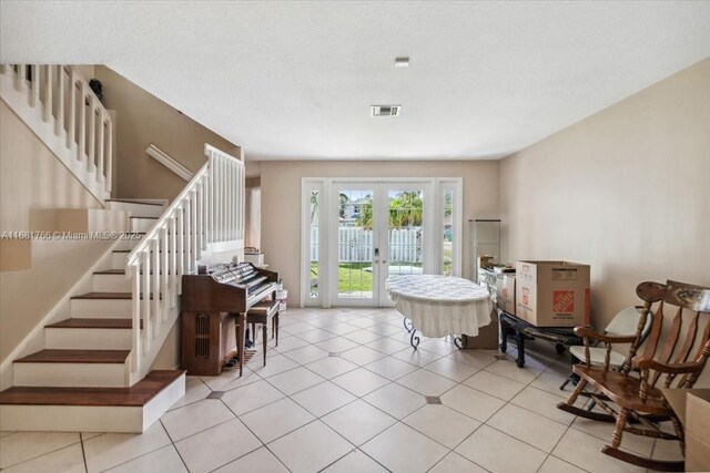 tiled entrance foyer featuring french doors