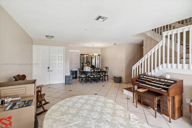 entryway featuring light tile patterned floors and an inviting chandelier