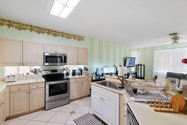 kitchen featuring light brown cabinets, sink, appliances with stainless steel finishes, and ceiling fan