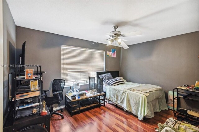 bedroom featuring ceiling fan and wood-type flooring