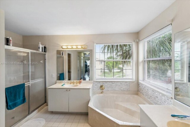 bathroom with vanity, tile patterned floors, and independent shower and bath