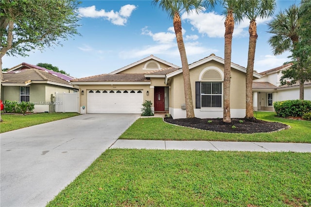 ranch-style home with a front yard and a garage