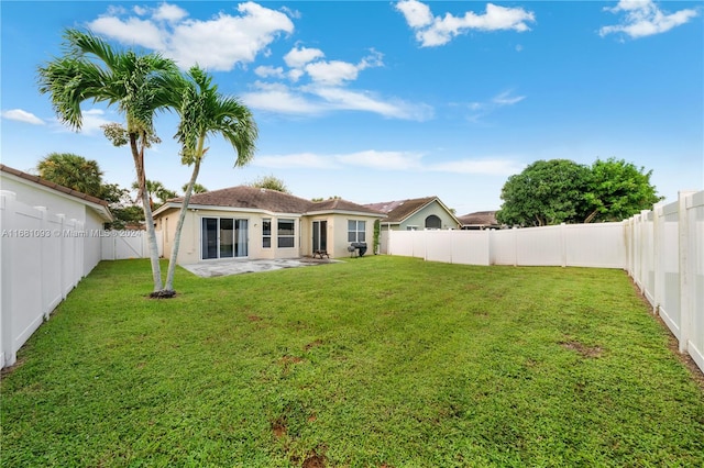 rear view of property featuring a patio and a lawn