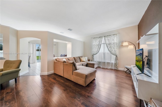 living room with ornamental molding and dark hardwood / wood-style flooring