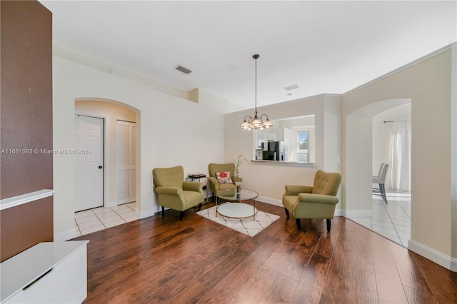 sitting room featuring light hardwood / wood-style floors and an inviting chandelier