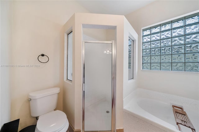 bathroom with toilet and plus walk in shower