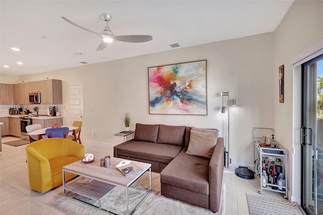living room featuring light tile patterned floors and ceiling fan