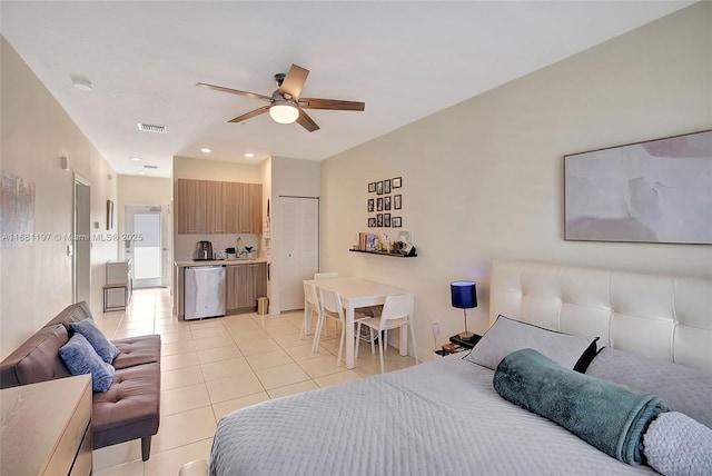 tiled bedroom featuring a closet and ceiling fan