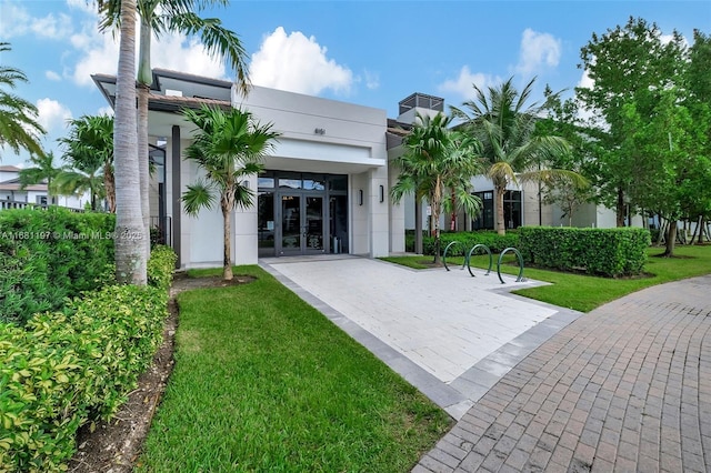 view of front of home featuring a front yard and french doors