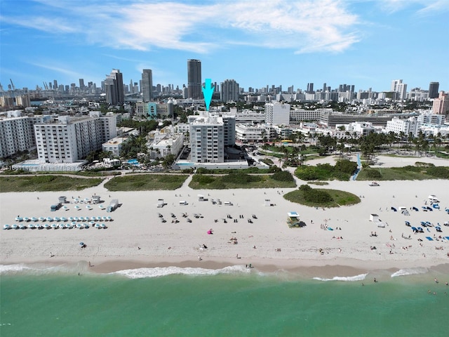 aerial view featuring a water view and a beach view