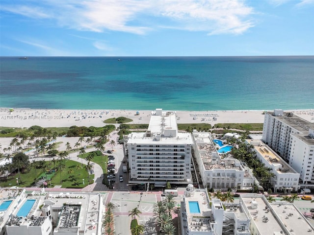 aerial view with a water view and a beach view