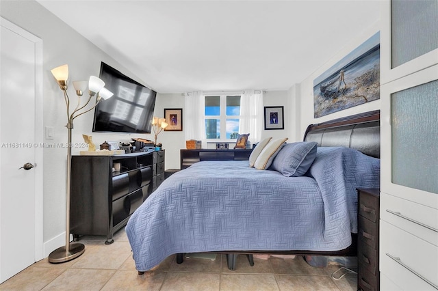 bedroom with light tile patterned floors