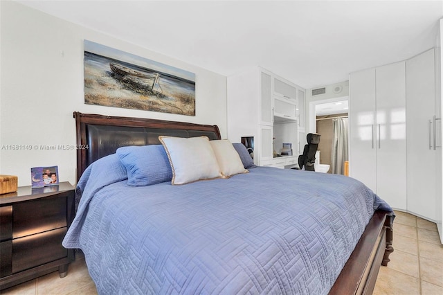 bedroom featuring light tile patterned flooring