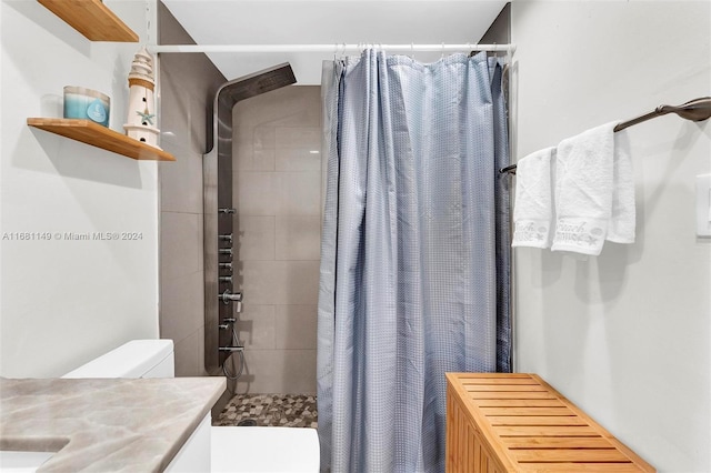 bathroom with vanity, toilet, and walk in shower