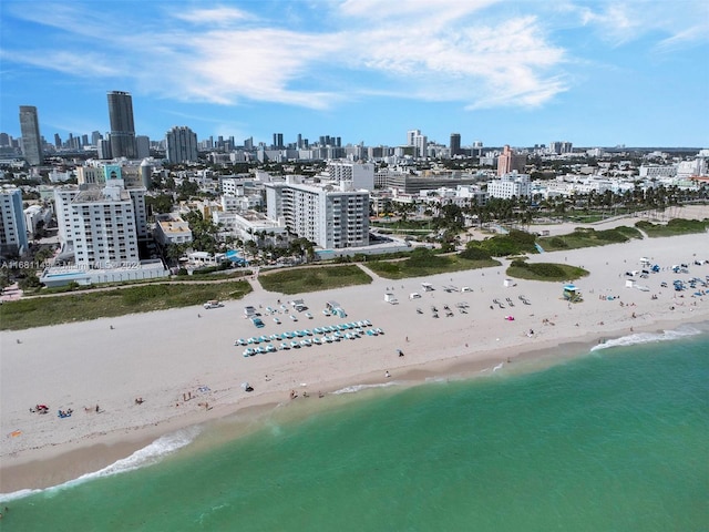 birds eye view of property featuring a view of the beach and a water view