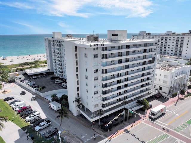 birds eye view of property featuring a water view and a beach view