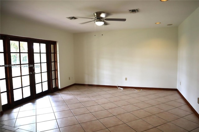 empty room featuring light tile patterned floors, french doors, visible vents, and baseboards