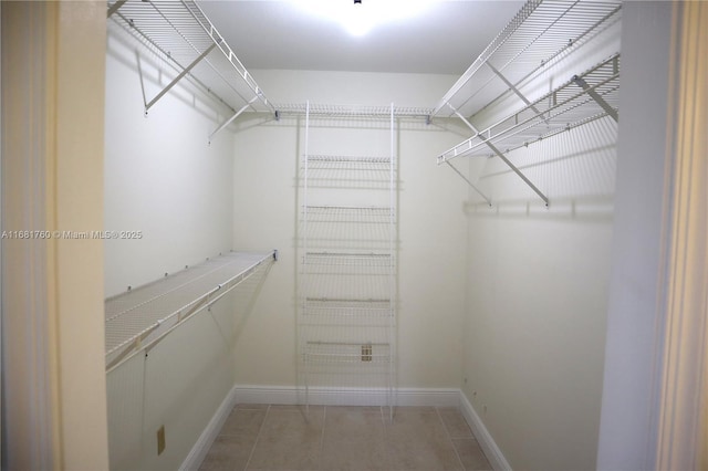 walk in closet featuring light tile patterned flooring