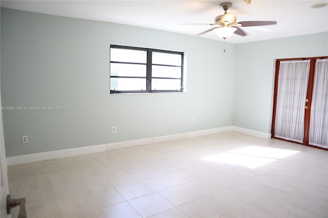 unfurnished room with light tile patterned floors and ceiling fan