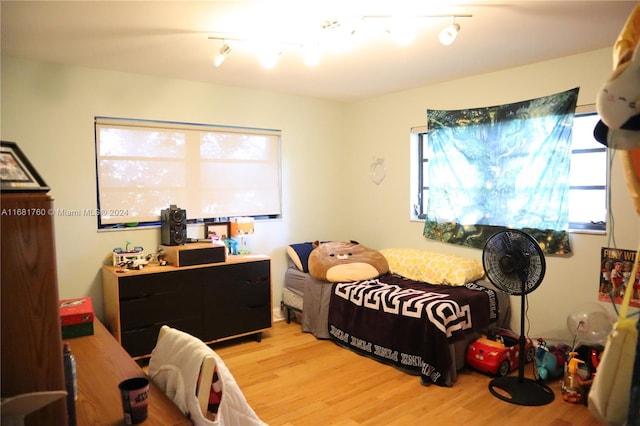 bedroom featuring light hardwood / wood-style flooring and rail lighting