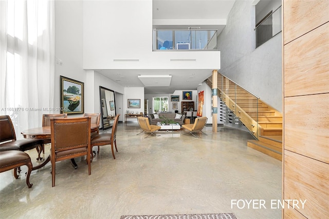 interior space featuring concrete flooring and a high ceiling