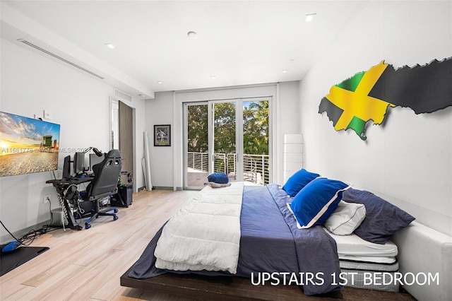 bedroom featuring hardwood / wood-style floors and access to outside