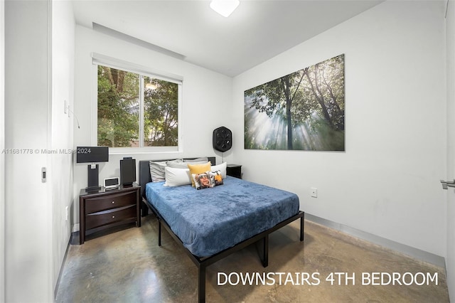 bedroom featuring concrete floors