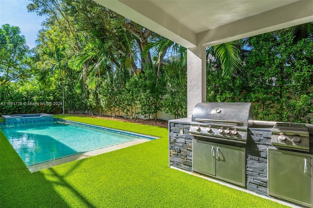 view of pool with area for grilling and a lawn