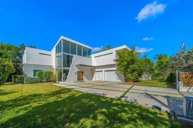 modern home with a front lawn and a garage