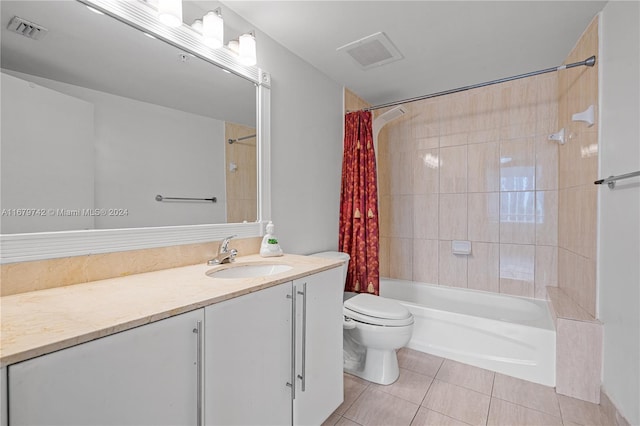 full bathroom with vanity, shower / bath combo with shower curtain, toilet, and tile patterned flooring