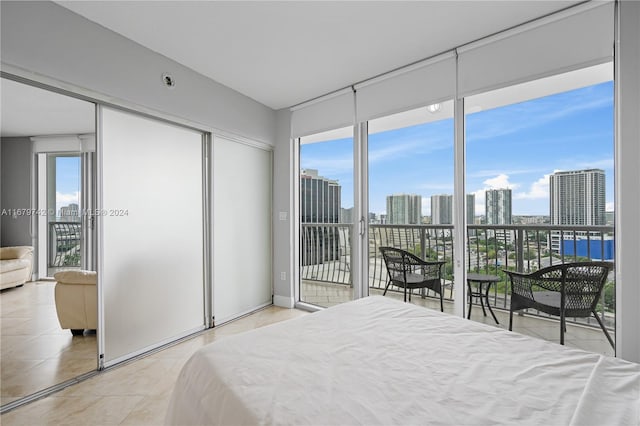 bedroom featuring access to outside and light tile patterned flooring