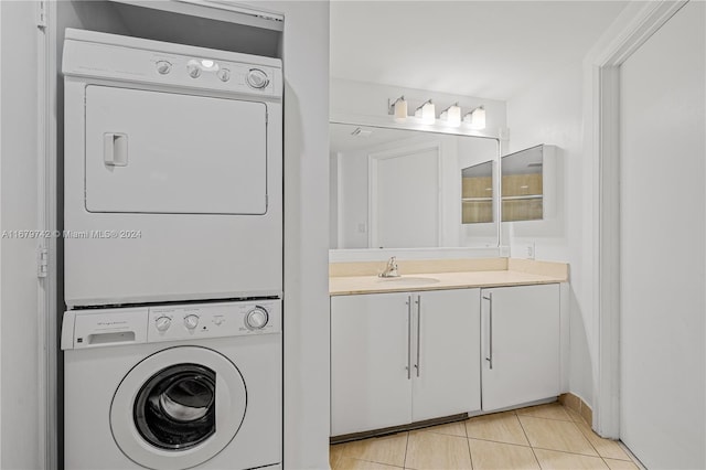 laundry room with sink, stacked washer / drying machine, and light tile patterned floors