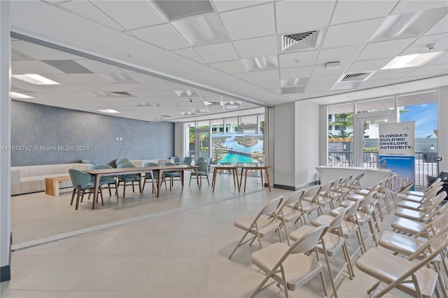 dining space featuring a drop ceiling