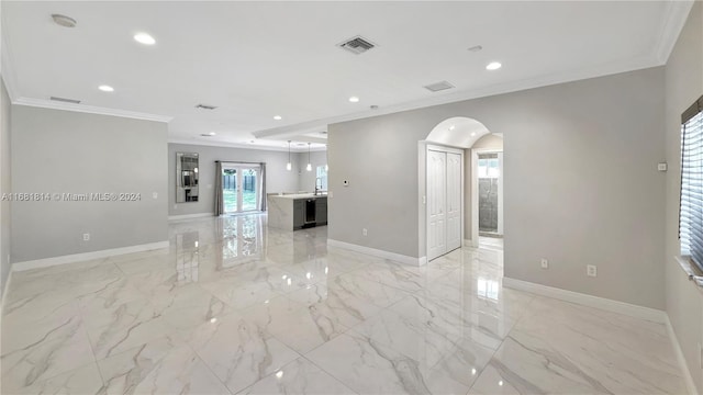 unfurnished living room featuring crown molding