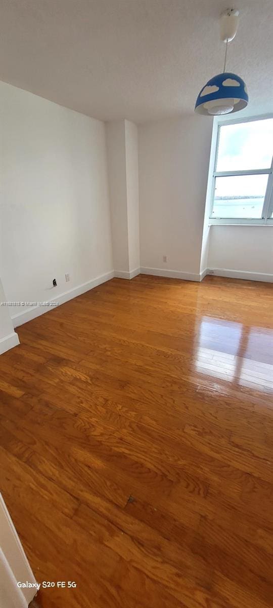 unfurnished room featuring hardwood / wood-style flooring