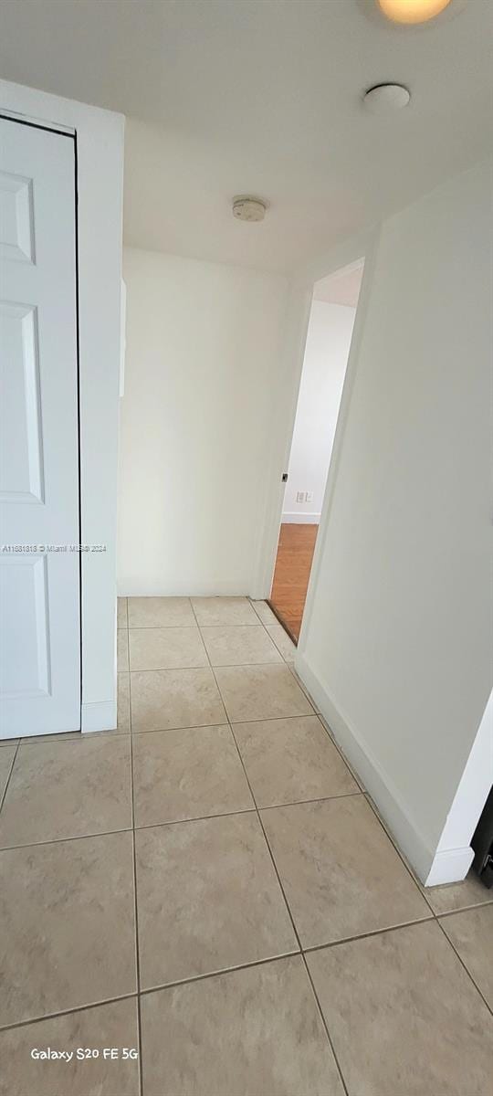 corridor featuring light tile patterned flooring