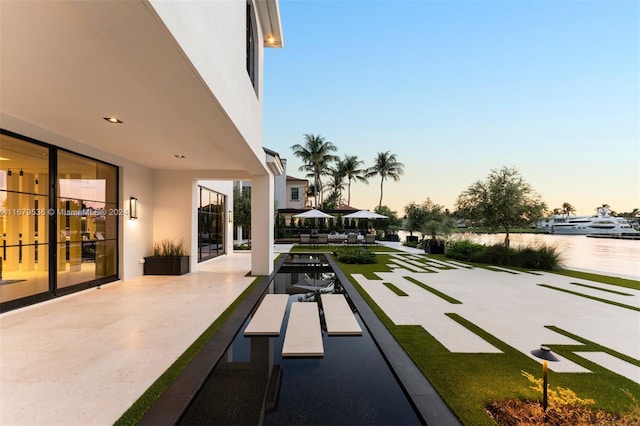 patio terrace at dusk with a water view