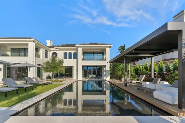 back of house featuring a patio and an outdoor hangout area