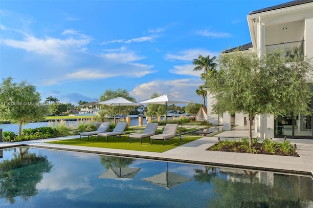 view of swimming pool with a water view