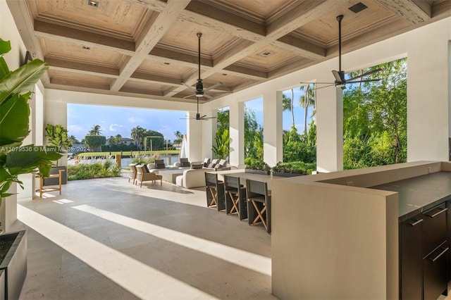 view of patio / terrace featuring an outdoor bar and ceiling fan