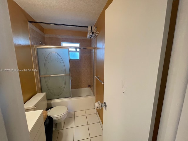 full bathroom with tile patterned floors, vanity, a textured ceiling, enclosed tub / shower combo, and toilet