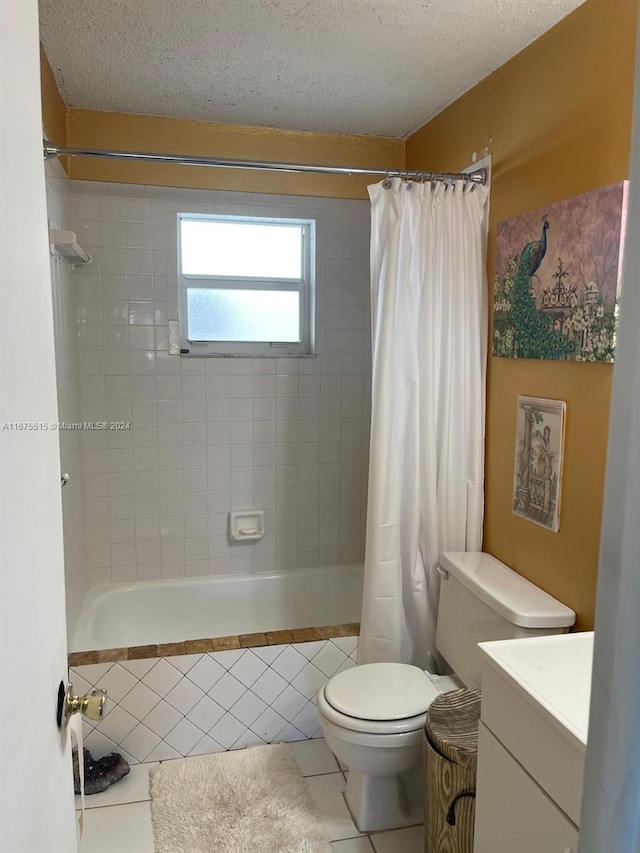 full bathroom with shower / bath combination with curtain, tile patterned floors, a textured ceiling, vanity, and toilet