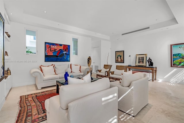 living room with a tray ceiling