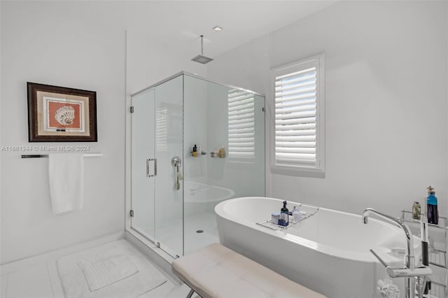 bathroom featuring tile patterned flooring and shower with separate bathtub