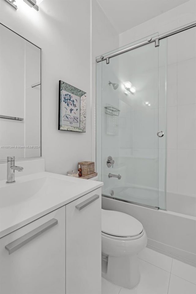 full bathroom with vanity, toilet, combined bath / shower with glass door, and tile patterned flooring