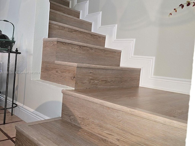 stairway with tile patterned flooring