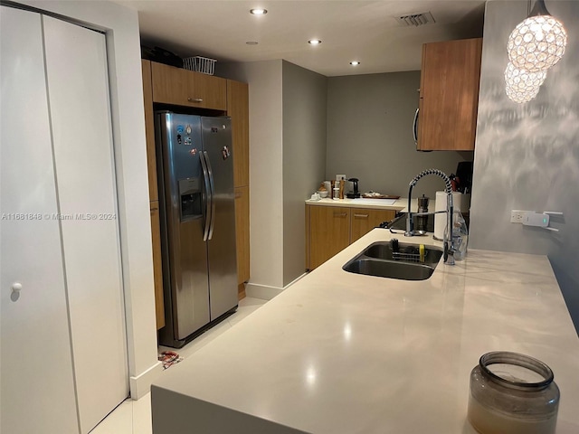 kitchen featuring sink and stainless steel refrigerator with ice dispenser