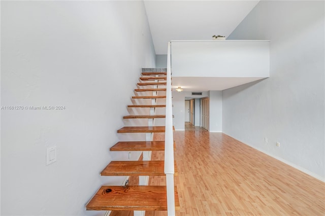 stairs with hardwood / wood-style floors