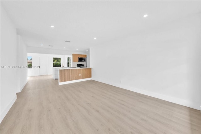 unfurnished living room with light hardwood / wood-style floors